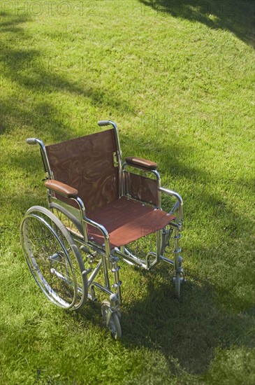 Empty wheelchair on a lawn.