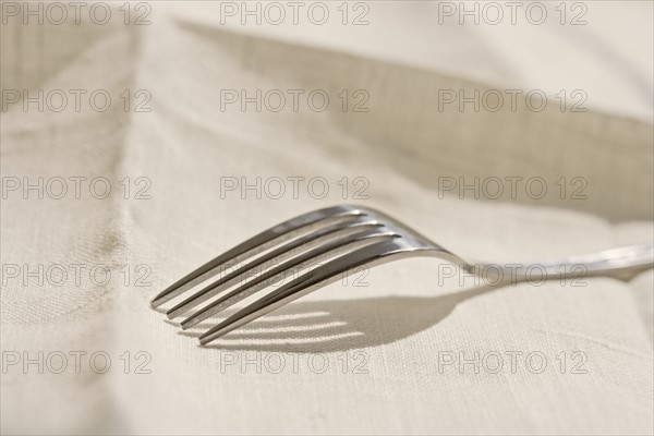 Closeup of metal fork on a napkin.