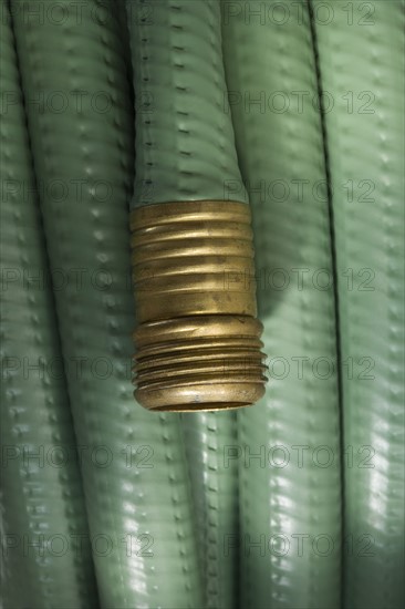 Closeup of wound up garden hose.