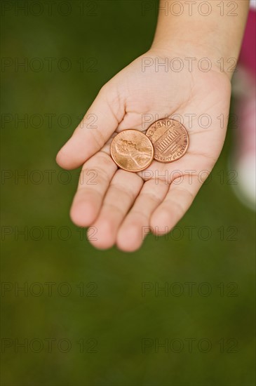 Closeup of pennies in childs palm.