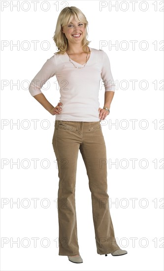 Woman standing with hands on hips.