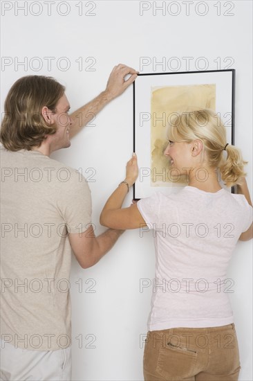 Couple hanging pictures.