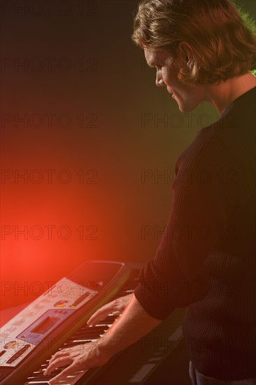 Man playing electronic keyboard.