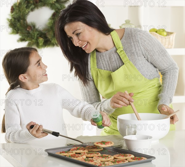 Mother and daughter baking Christmas cookies.