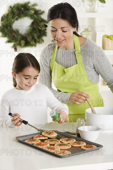 Mother and daughter baking Christmas cookies.