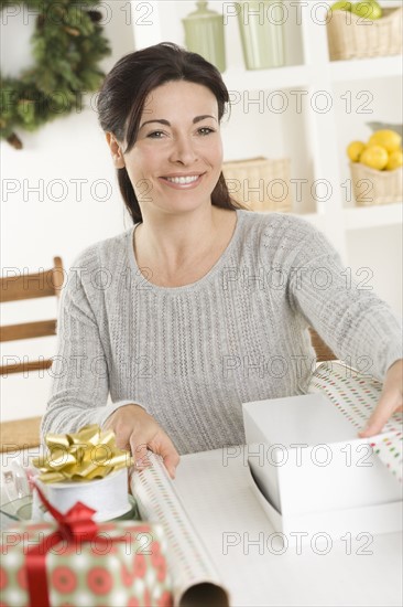Woman wrapping Christmas gifts.