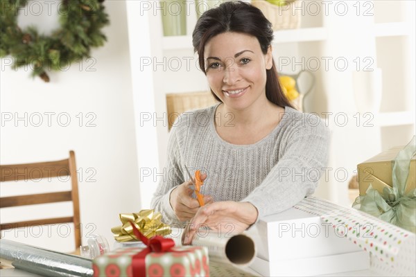 Woman wrapping Christmas gifts.