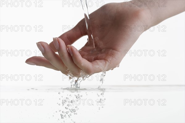 Hand touching water.