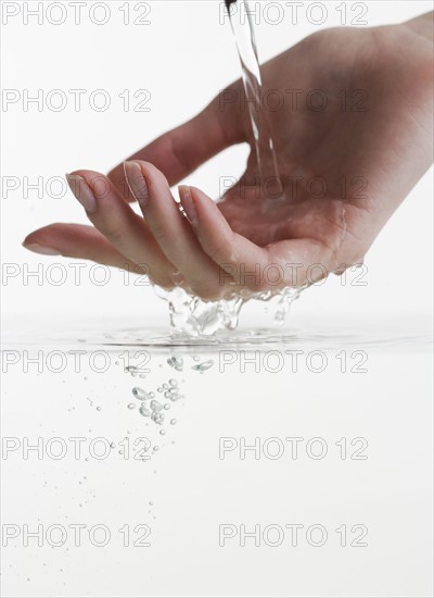 Hand touching water.