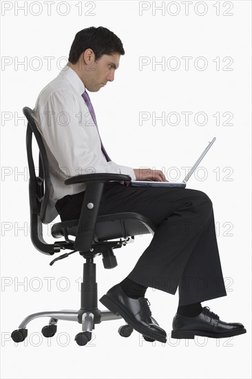 Businessman typing on laptop.