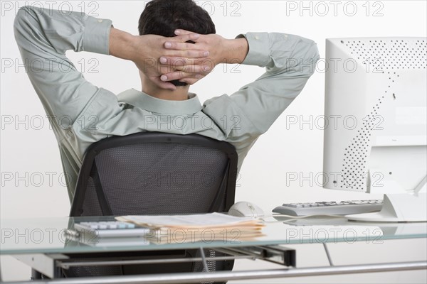 Man relaxing at his desk.