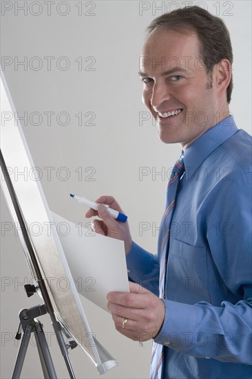 Portrait of businessman at presentation board.