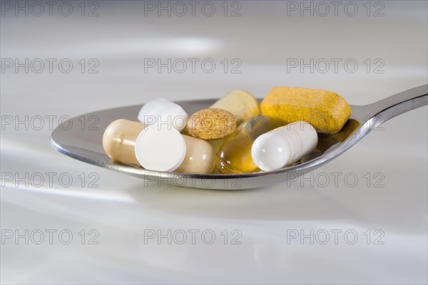 Still life of a spoonful of pills.