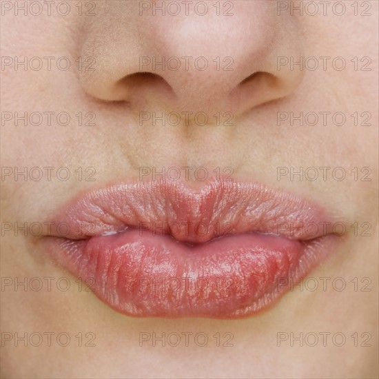 Close up of puckered lips.