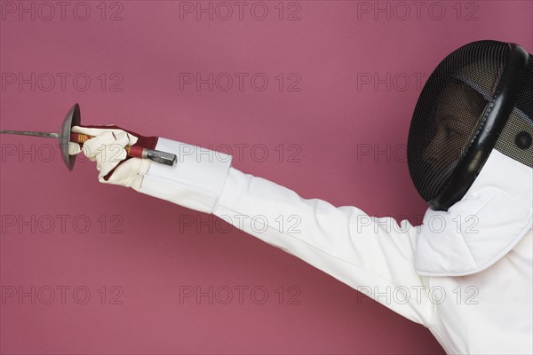 Person engaged in fencing.