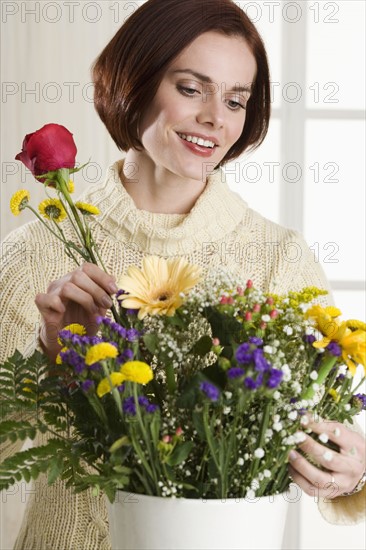 Portrait of woman arranging flowers.