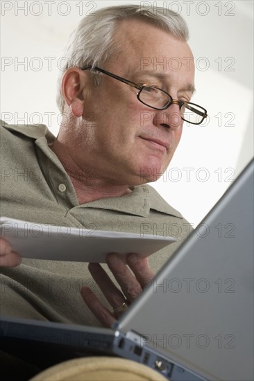 Man using laptop computer at home.