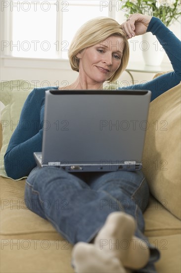 Woman using laptop computer at home.