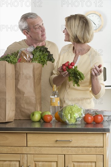 Couple unloading groceries.