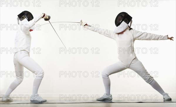 Two people fencing.