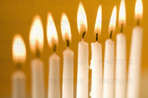 Candles burning in a menorah.