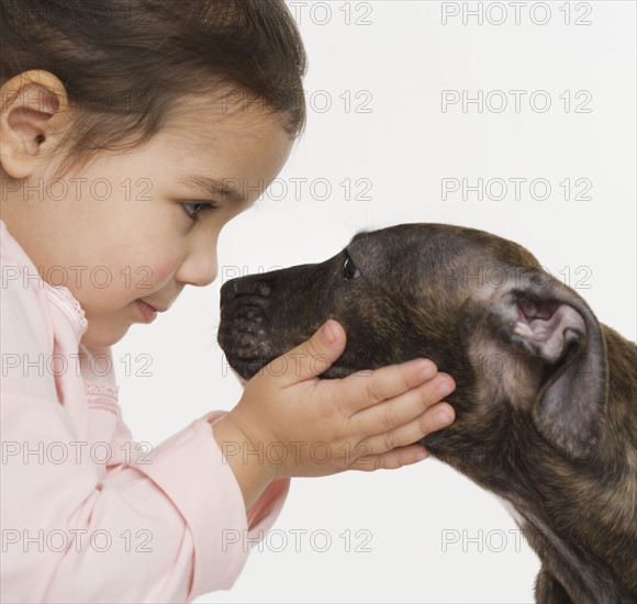 Hispanic girl with puppy.