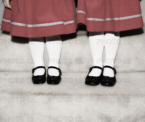 Feet and legs of two girls.