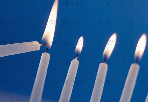 Lighting a menorah.