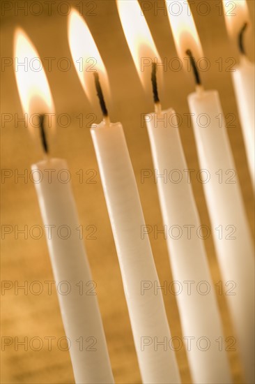 Candles burning in a menorah.