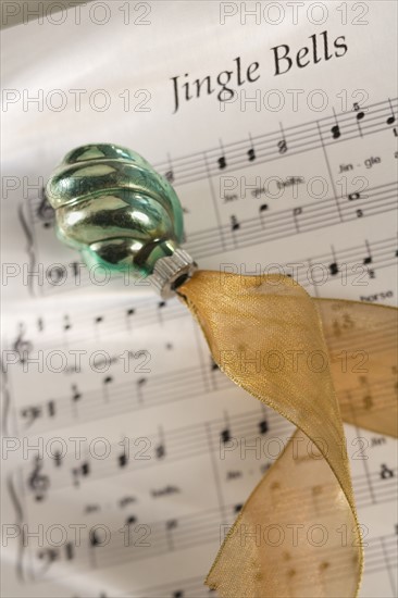 Closeup of Christmas ornanament and music.