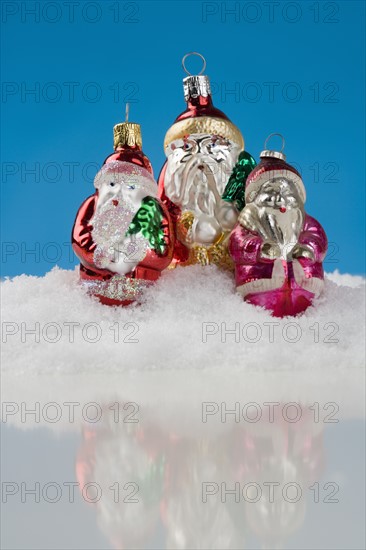 Three Santa Claus Christmas ornanaments.