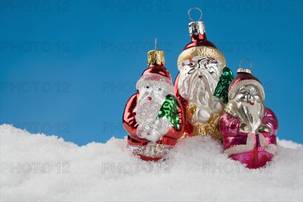 Three Santa Claus Christmas ornanaments.