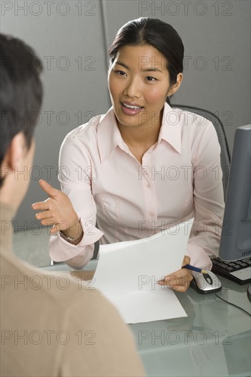 Businesswoman talking to co-worker.