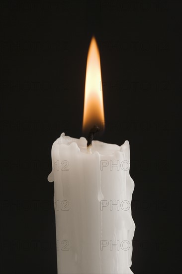 Closeup of a burning candle.