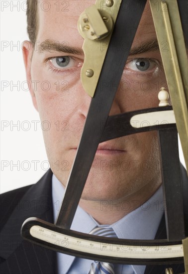 Man looking through an octant.