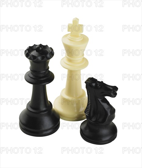 Closeup of three chess pieces.