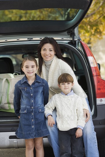 Portrait of mother with son and daughter.