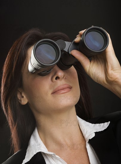 Woman looking through binoculars.