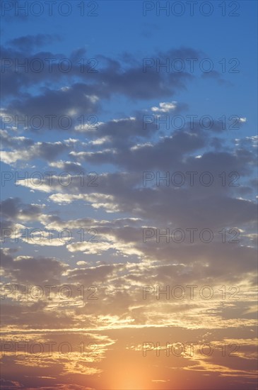 Sunset with puffy clouds.