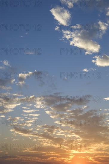 Sunset with puffy clouds.