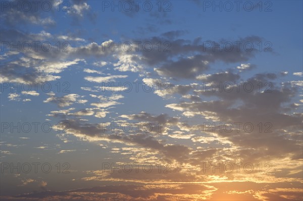 Sunset with puffy clouds.