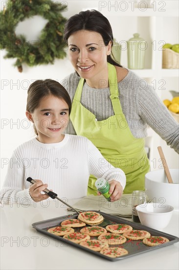 Mother and daughter baking Christmas cookies.