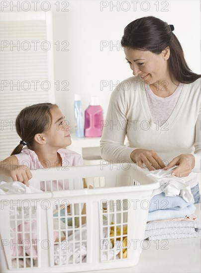 Mother and daughter doing laundry.