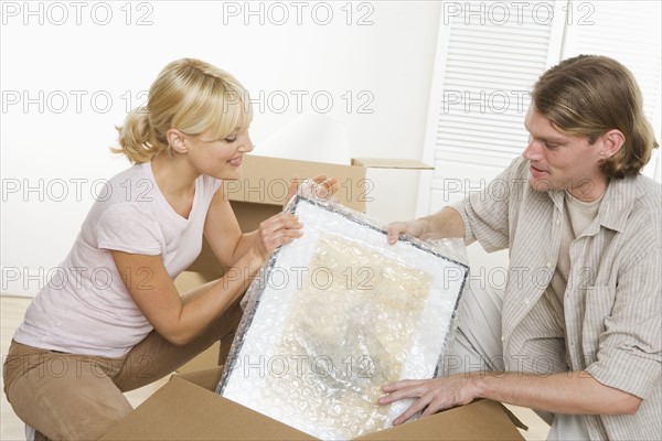 Couple unpacking after moving.