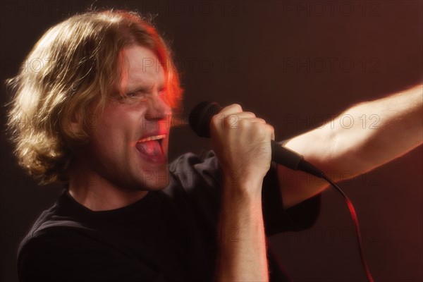 Man singing into microphone.