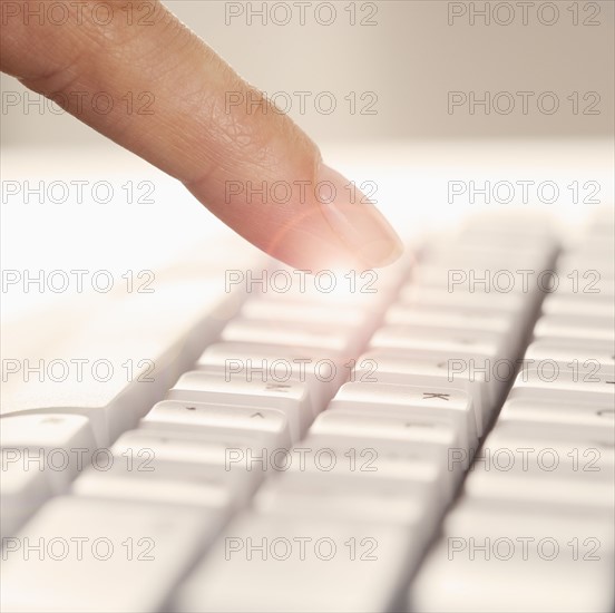 Finger and computer keyboard.