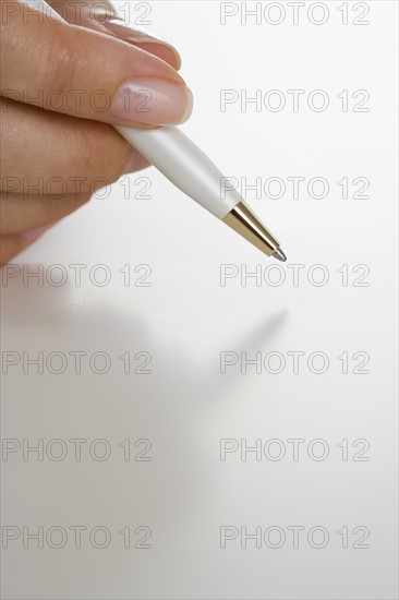 Closeup of hand holding pen.