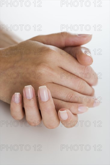 Woman with clasped hands.