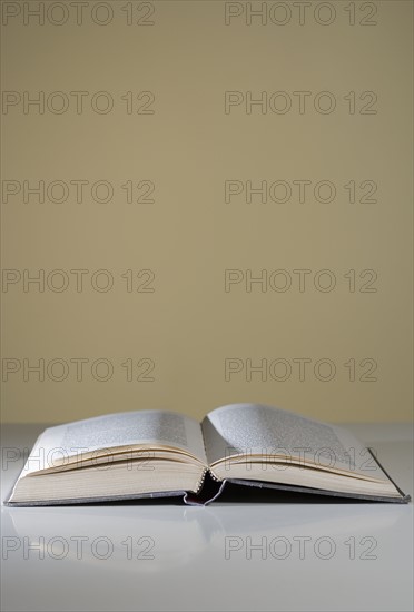 An open book lying on a table.