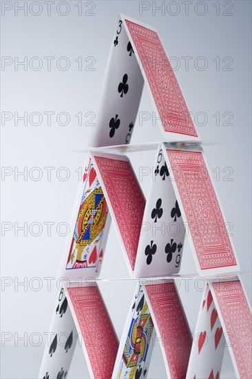 Playing cards stacked into a pyramid.